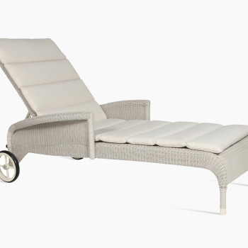 Vincent Sheppard Safi sunlounger in old lace with armrests, adjustable backrest, and cushioned seating, featuring a woven rattan design and wheels for easy mobility.